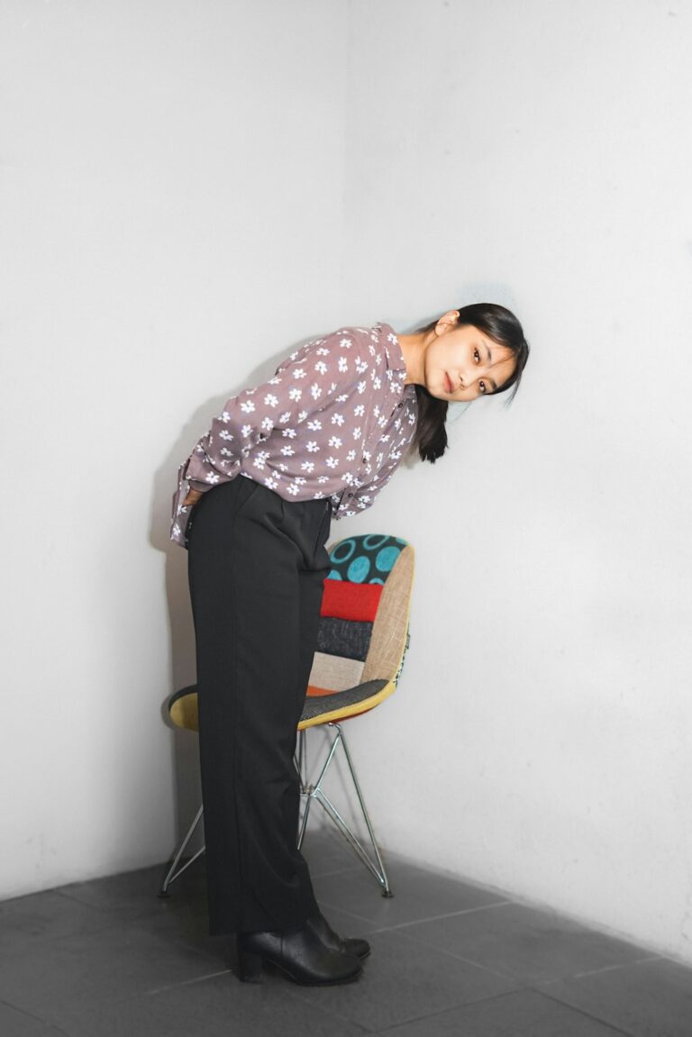 Person practicing neutral posture at a desk with a supported spine and monitor at eye level.